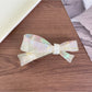 Beau acetate bow hair clip with light reflections emphasizing glossy finish
