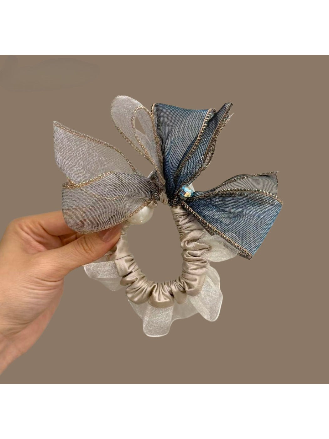 Top view of bow hair tie showing fabric texture and elastic band