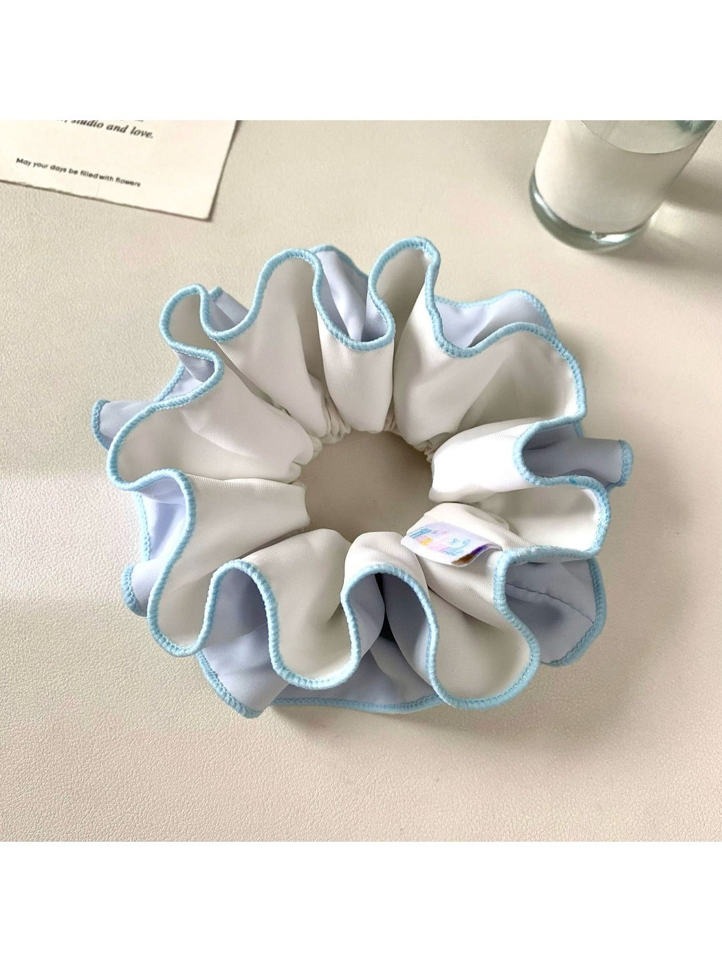 Gifty scrunchie styled on a wrist with neutral outfit, highlighting minimalist fashion