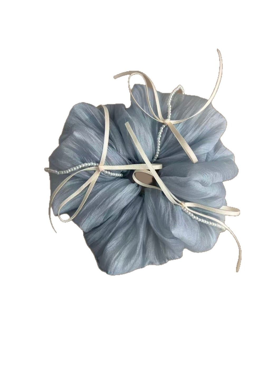 Blue tulle scrunchie with ribbon bow displayed on a wooden surface