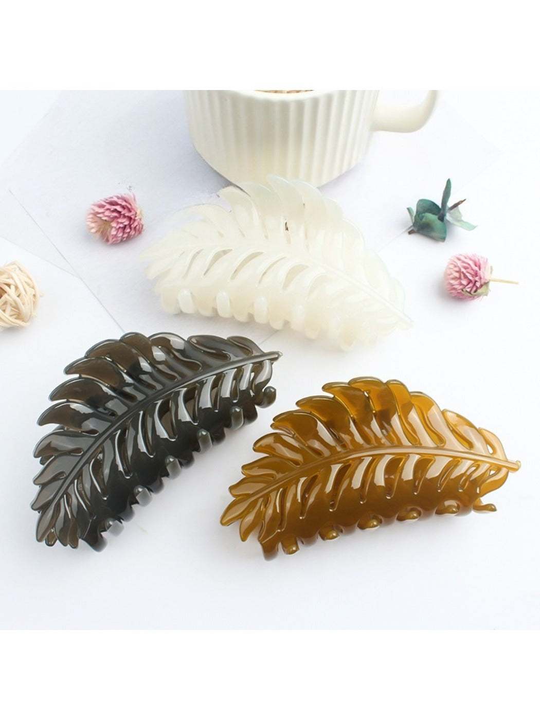 Beau leaf hair clip held in hand displaying size and shape