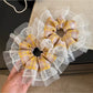 Close-up of vintage yellow plaid scrunchie fabric texture