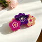 Beau hair clip styled in dark hair highlighting its elegant design and shine
