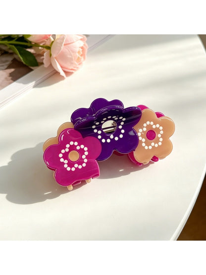 Beau hair clip styled in dark hair highlighting its elegant design and shine