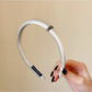 Gifty satin headband displayed on a mannequin head highlighting minimalist design