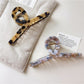 Side view of Beau vintage crisscross hair claw clip highlighting curved teeth