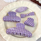 Side view of purple plaid hair claw clip showing spring mechanism