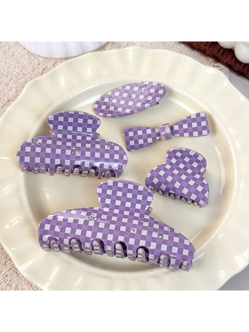Side view of purple plaid hair claw clip showing spring mechanism