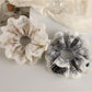 Close-up of Gifty vintage double layer scrunchie with floral print on fabric