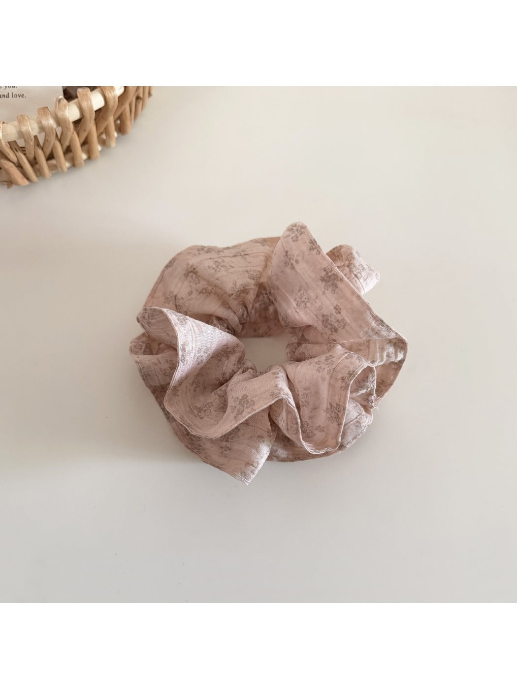 Gifty floral scrunchie paired with matching hair accessories on a wooden surface