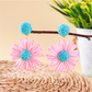 Top view of earedge raffia stud earrings highlighting detailed floral pattern