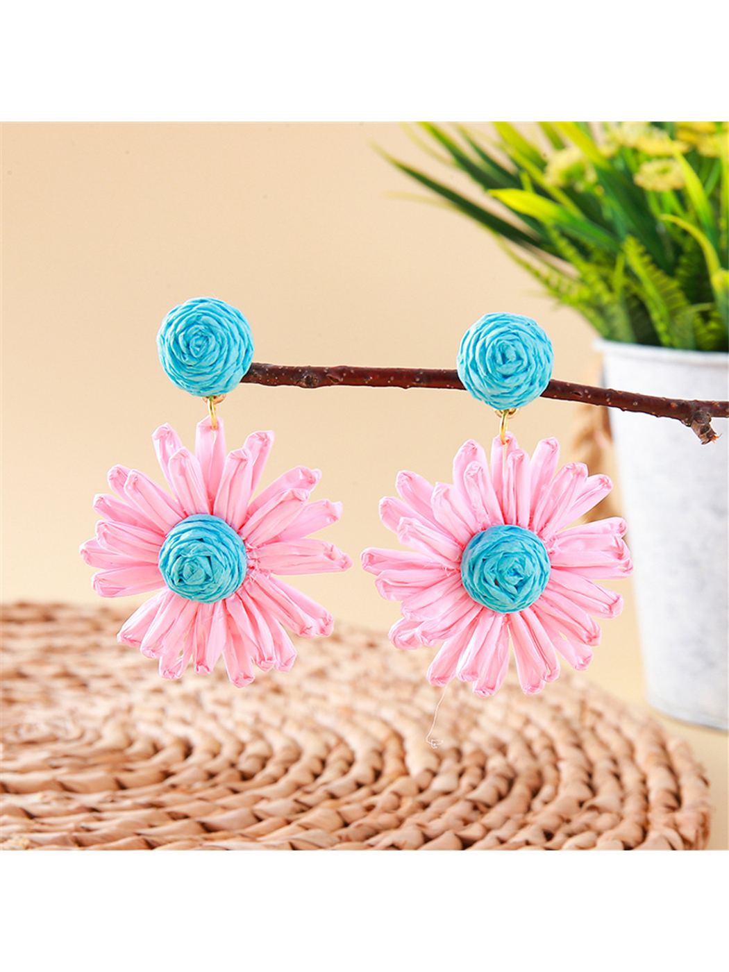 Top view of earedge raffia stud earrings highlighting detailed floral pattern