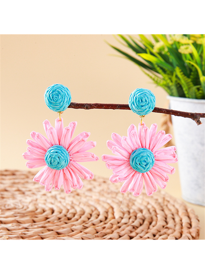 Top view of earedge raffia stud earrings highlighting detailed floral pattern