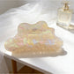 Beau holographic claw clip reflecting light with rainbow colors