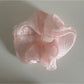 Scrunchie made of lightweight sheer tulle fabric in beige color