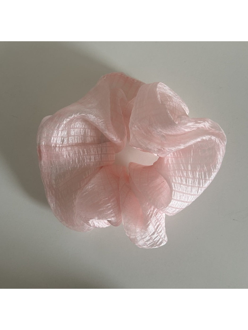 Scrunchie made of lightweight sheer tulle fabric in beige color