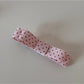 Beau hair clip showing detailed floral pattern and smooth finish
