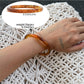 Model adjusting Lovra ombre bangle bracelet on wrist in natural light