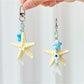 Close-up of elegant starfish shaped keychain in gold finish on white background
