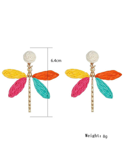 Pair of raffia dragonfly earrings displayed on a white background