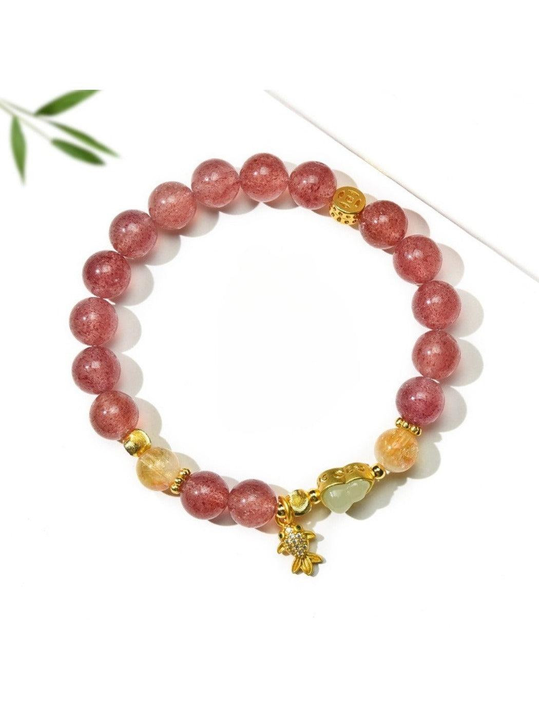 Close-up of goldfish pendant with crystal beads on Lovra bracelet