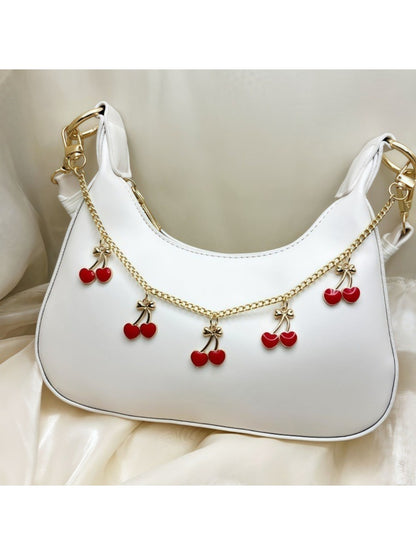 Minimalist cherry-shaped bag charm with a silver keyring on a white background