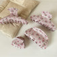 Side view of Beau pink rose print hair claw clip highlighting clip mechanism