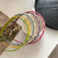 Side view of Gifty solid color wavy headband highlighting wave design