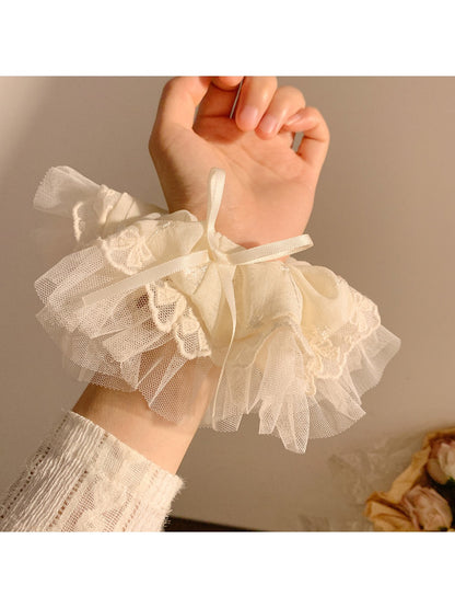 Gifty bow scrunchie styled on a wrist as a fashion accessory