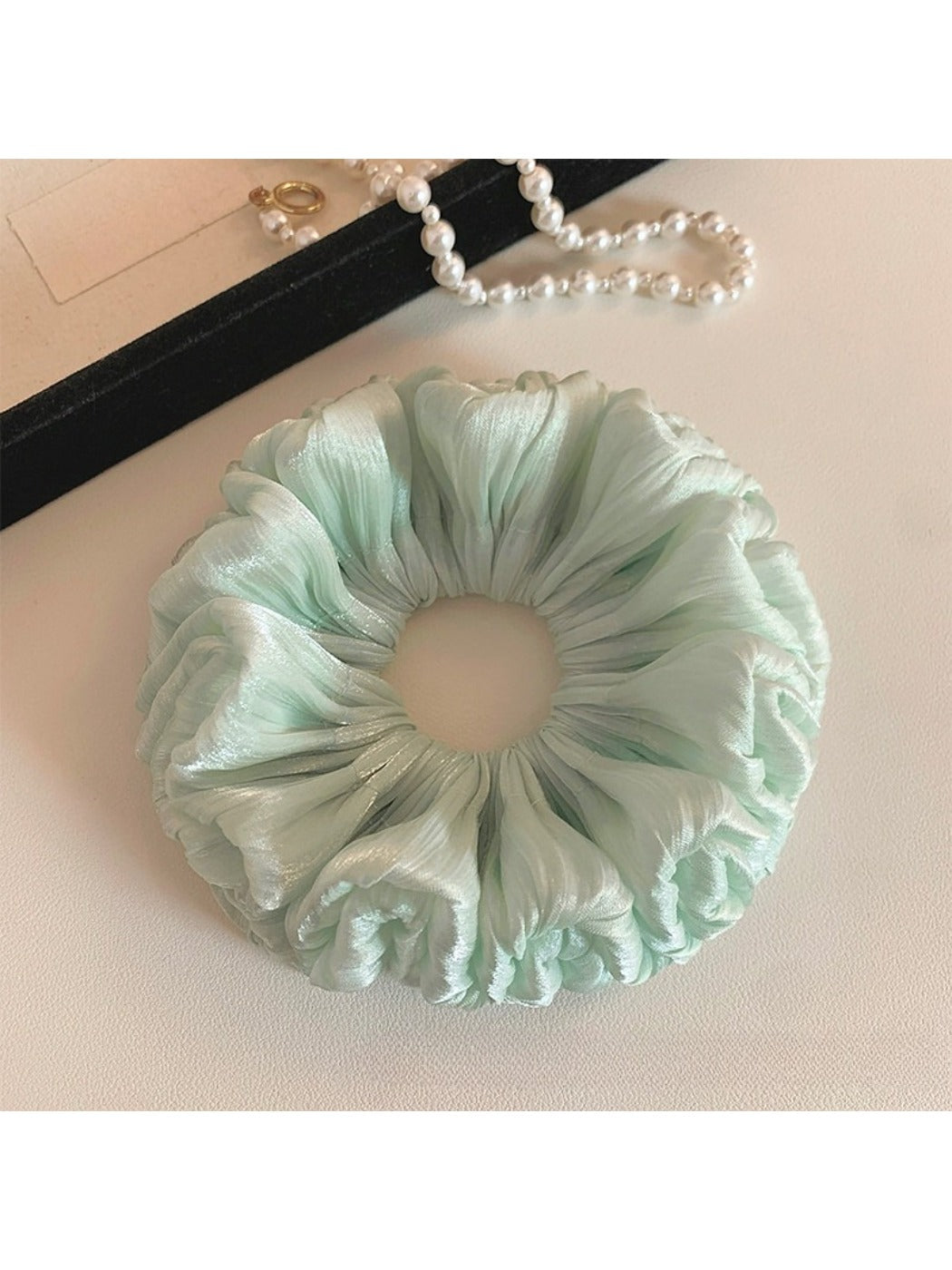 Close-up of green double layered scrunchie showing fabric details