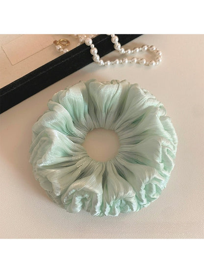 Close-up of green double layered scrunchie showing fabric details
