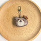 Bear charm keychain displayed with other animal-themed keychains