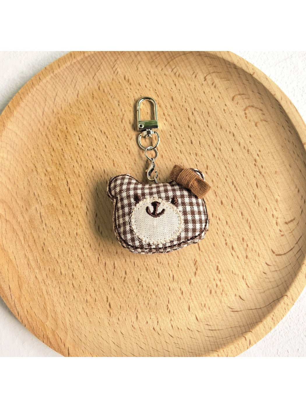 Bear charm keychain displayed with other animal-themed keychains
