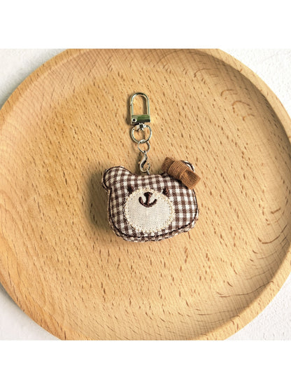 Bear charm keychain displayed with other animal-themed keychains