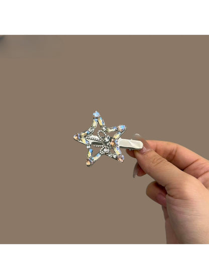 Side view of Beau rhinestone star hair clip showing metal clasp and detailed stones