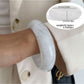 Lovra modern wide fit bracelet worn with other minimalist jewelry pieces