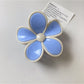 Beau color block flower claw clip with pastel pink and cream petals on neutral background