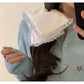 Hand holding satin white lace trim scrunchie showing texture and detail