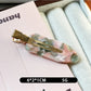 Beau acetate invisible hair clip partially open to reveal inner clasp