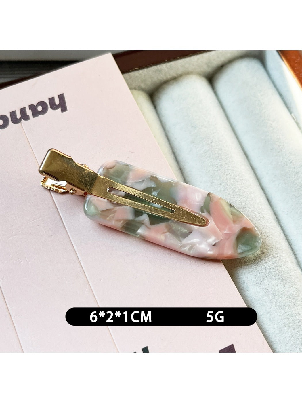 Beau acetate invisible hair clip partially open to reveal inner clasp