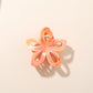 Beau flower-shaped hair clip with openwork design and bright colors in natural light