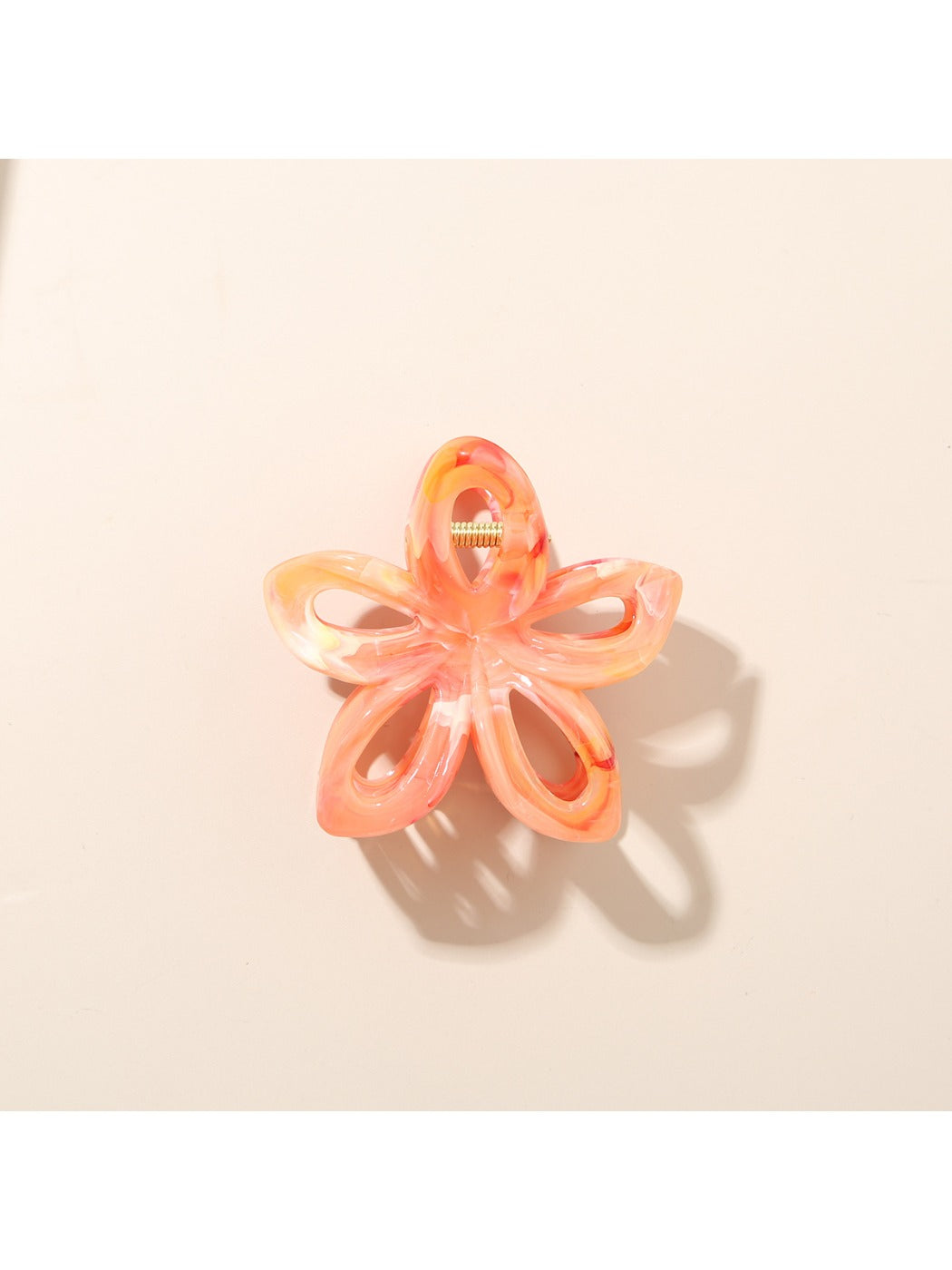 Beau flower-shaped hair clip with openwork design and bright colors in natural light