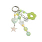 Hand holding Keypus green beaded keychain showing size and details