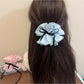 Gifty scrunchie styled in a ponytail on a model with brown hair
