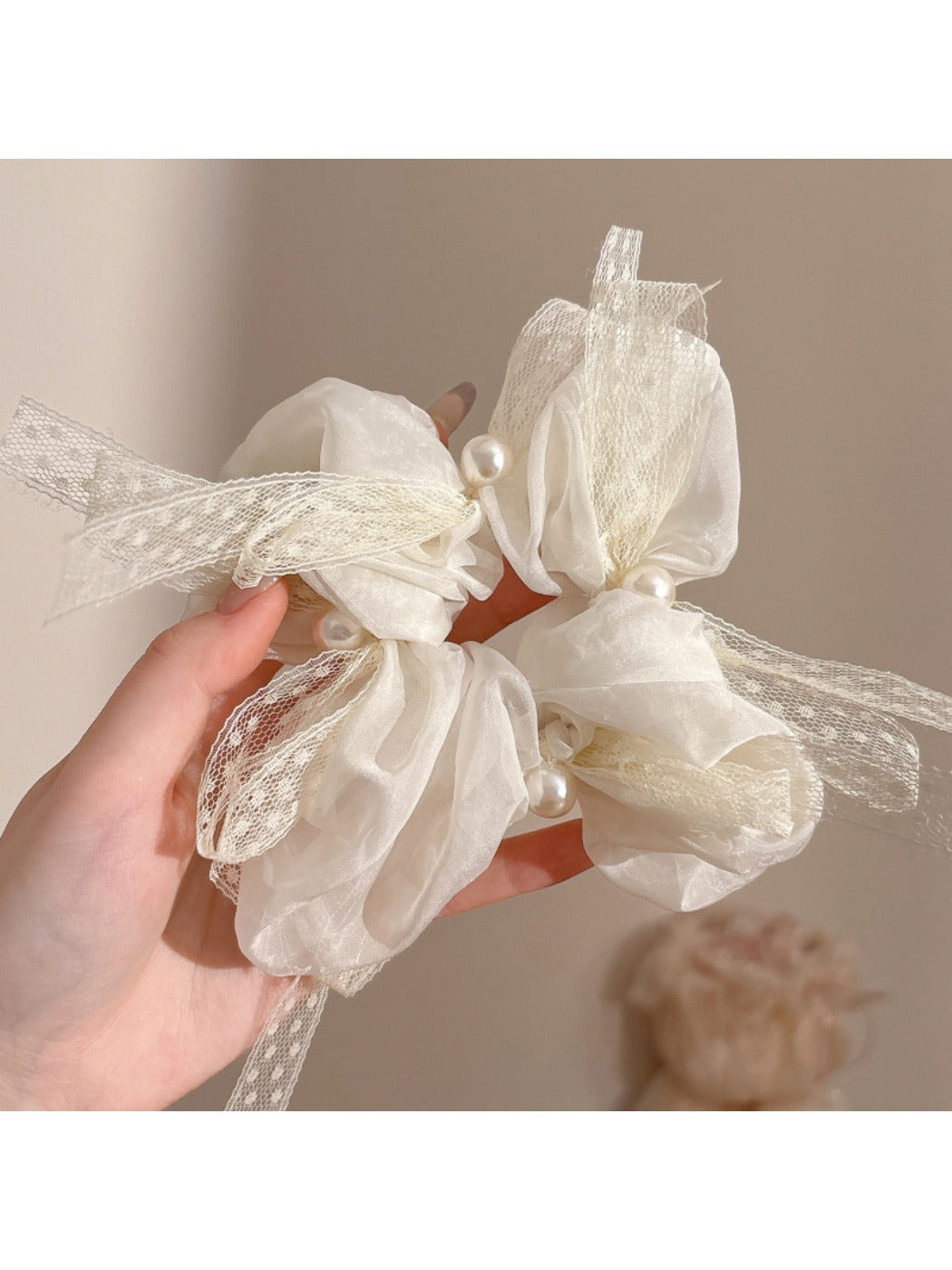Model wearing Gifty scrunchie in hair with bow positioned on top
