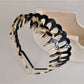 Close-up of Gifty toothed wave headband showing smooth acetate texture