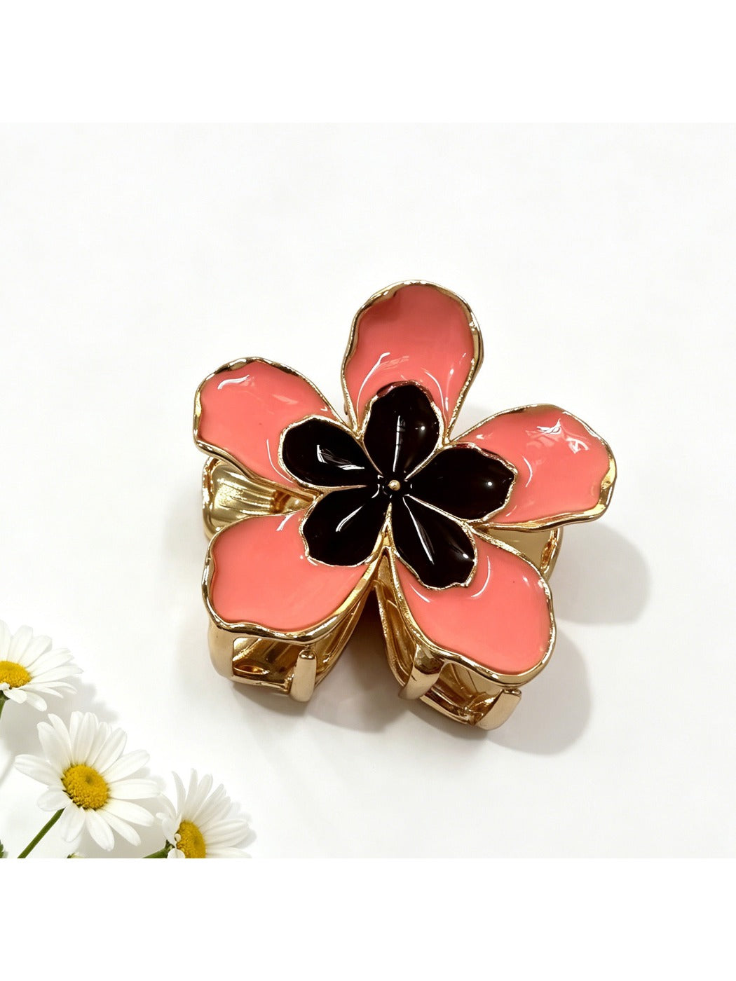 Beau flower hair clip held in hand, showing size and intricate fabric petal details