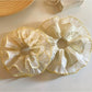 Yellow printed scrunchie displayed on a white surface