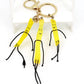 Mini French fries keychain attached to a silver keyring on a white background