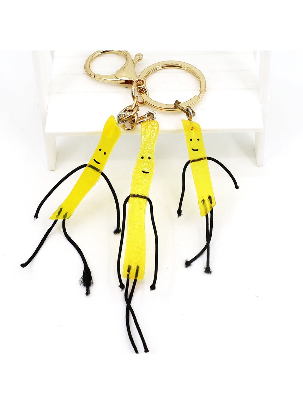 Mini French fries keychain attached to a silver keyring on a white background